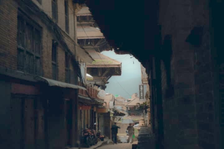 The same street photo after LuminaClean lifts the shadows and smooths the noise